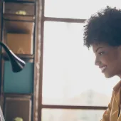 woman smiling while working