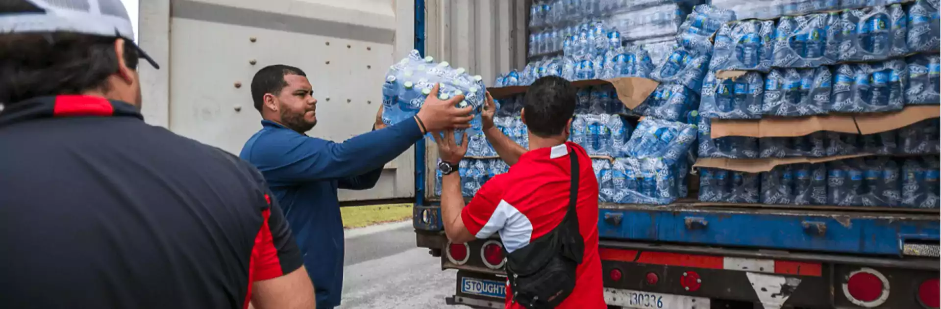 Hurricane Relief Workers Sharing Water Bottles