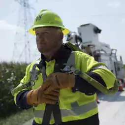 people - man in yellow and hard hat walking in road matt turley