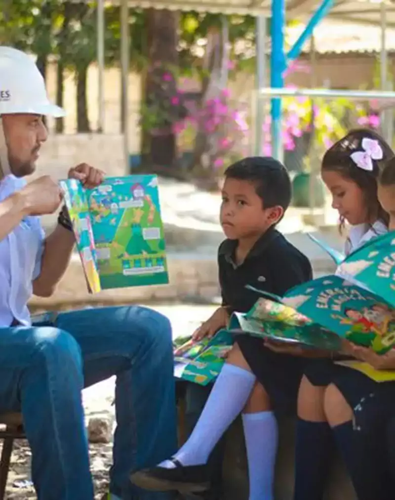 Energy worker reading storybook to children.