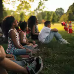 kids sitting on grass