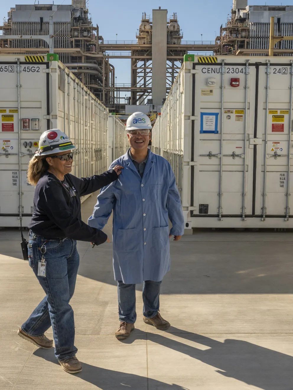 Man and woman in front of BESS facility