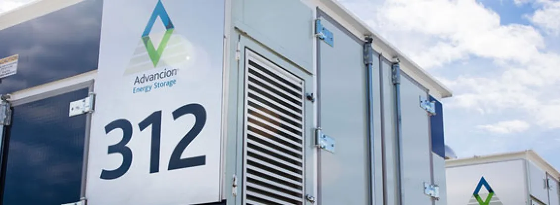 Close-up of Advancion Energy Storage units with the number 312 on a sunny day with clouds in the sky.