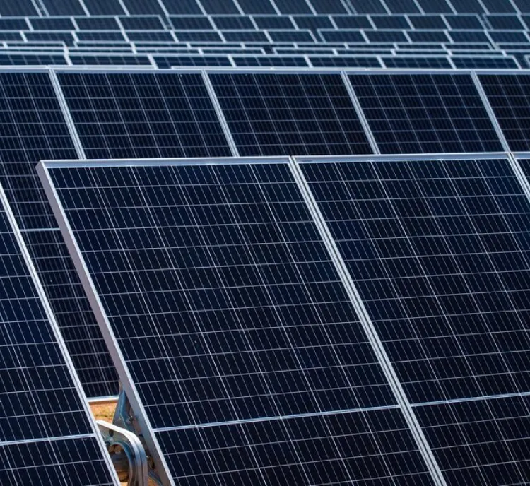Close-up view of multiple solar panels arranged in rows, capturing sunlight for energy production.