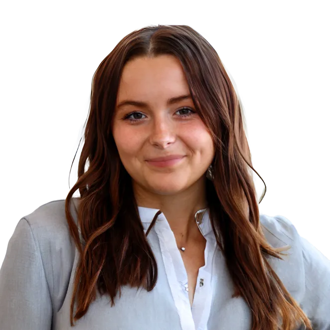 Claire Spitz headshot. Young woman with long brown hair wearing a light gray blouse and white shirt, smiling.