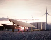 A renewable energy facility at sunset featuring solar panels in the foreground, wind turbines in the background, and energy storage units lined up.